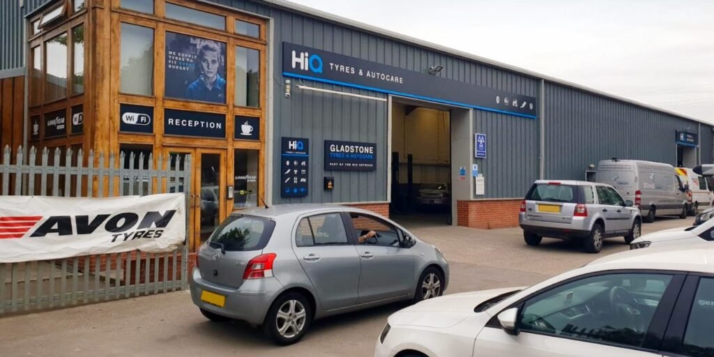 Tyre shop with vehicles and signage.