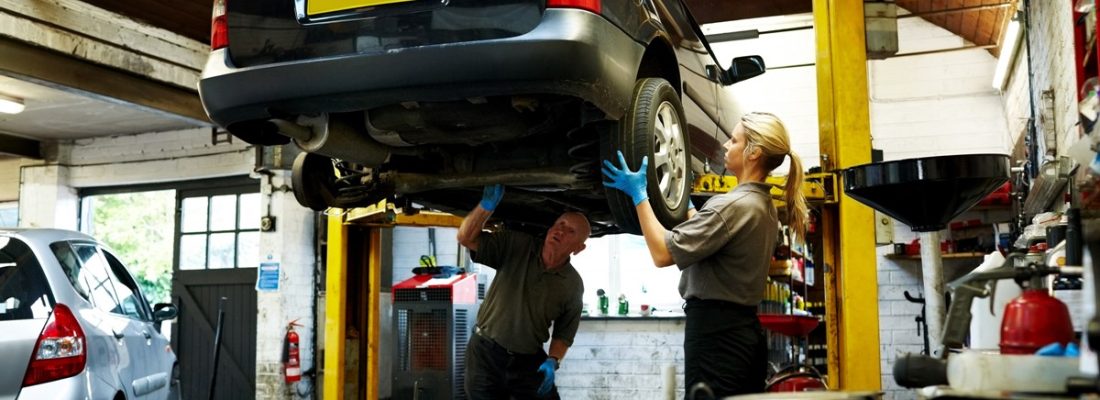 Driver checking car tyre tread depth before MOT test in York